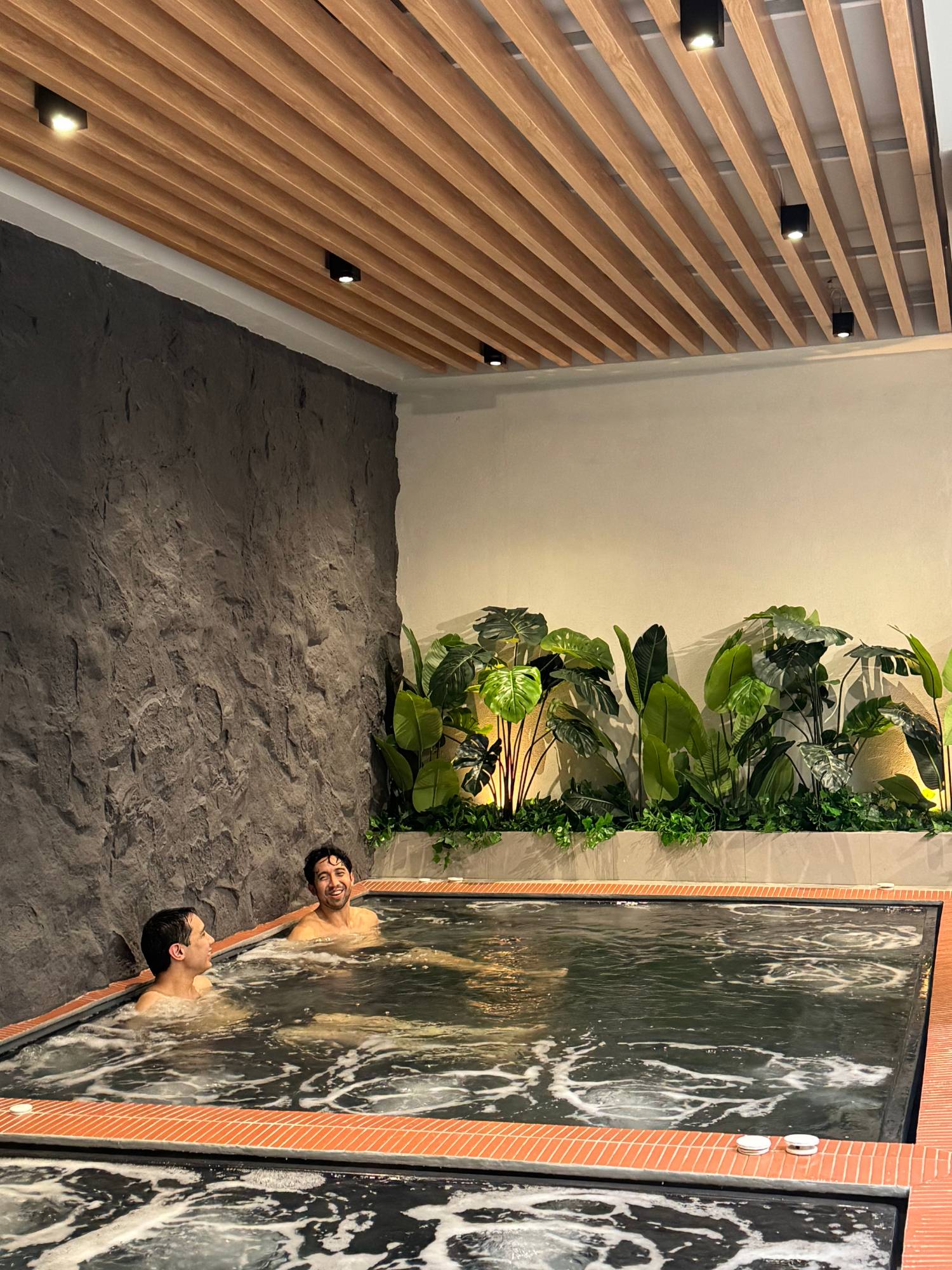 Guests using the hot bath pools at The Ice Bath Club